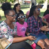 Members listen at "Prayer in the Park" event.